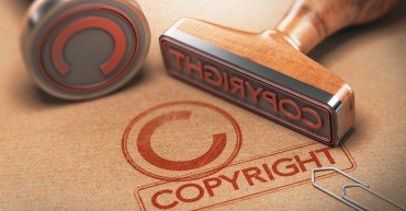 3D illustration of two rubber stamps with copyright word and symbol over kraft paper background, Concept of copyrighted material