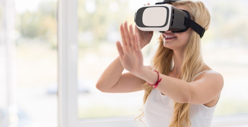 Young Blonde Woman Wear Virtual Reality Digital Glasses, Happy Smiling Beautiful Girl Over Big Window