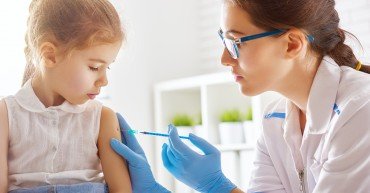 A doctor makes a vaccination to a child