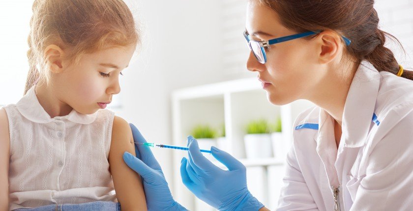 A doctor makes a vaccination to a child