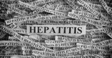 Hepatitis. Torn pieces of paper with the words Hepatitis. Concept Image. Black and White. Closeup.