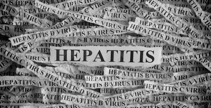 Hepatitis. Torn pieces of paper with the words Hepatitis. Concept Image. Black and White. Closeup.